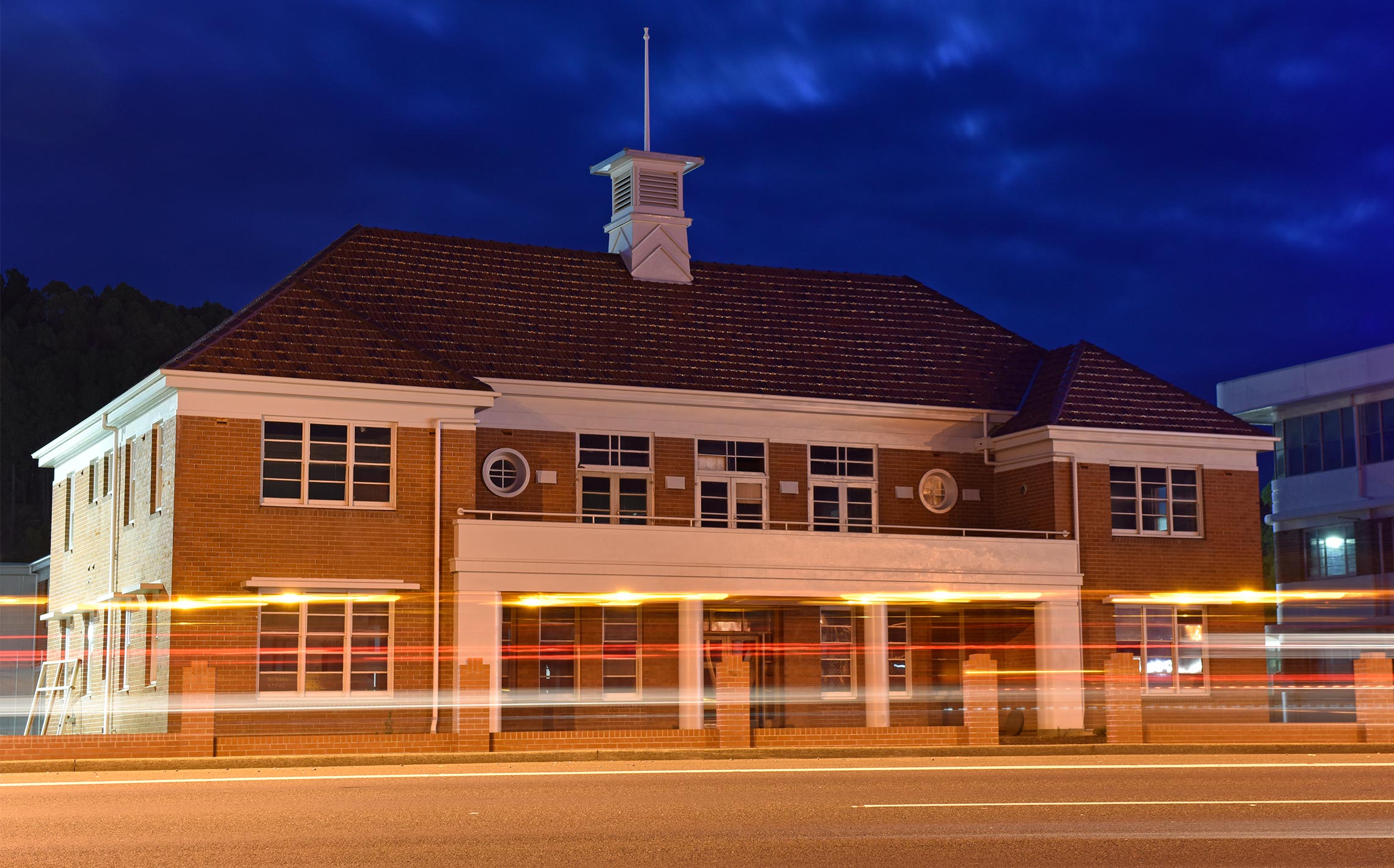 Restored paper mill office building in Burnie, Tasmania with blurred lights. 